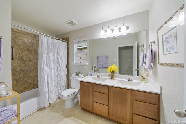 full bathroom featuring shower / tub combo with curtain, vanity, a textured ceiling, tile patterned floors, and toilet