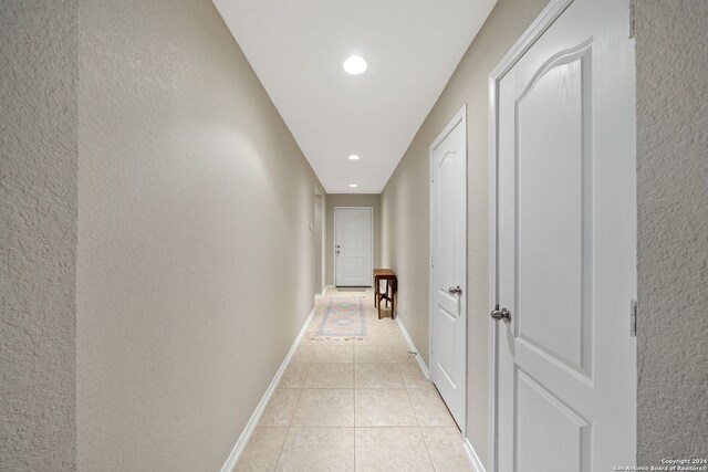 corridor featuring light tile patterned floors