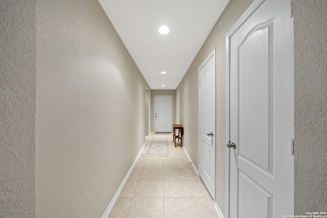 hallway with light tile patterned floors