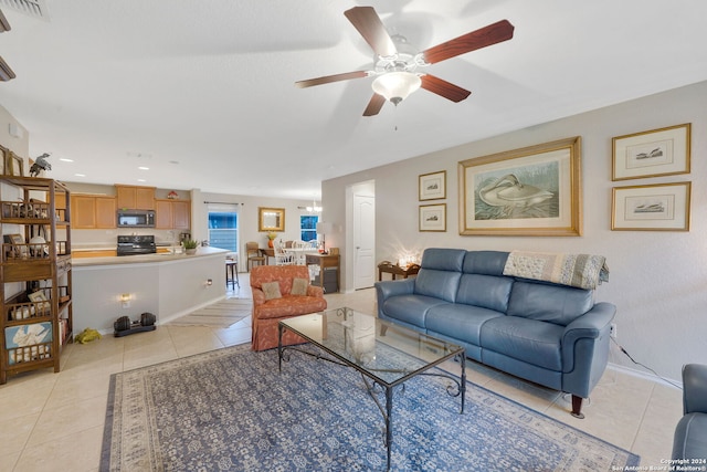 living room with light tile patterned floors and ceiling fan