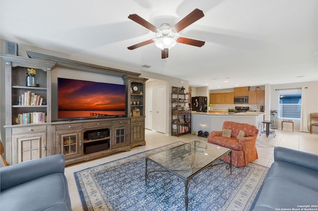 living room featuring light tile patterned flooring and ceiling fan