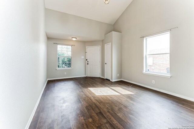 spare room with hardwood / wood-style flooring and high vaulted ceiling