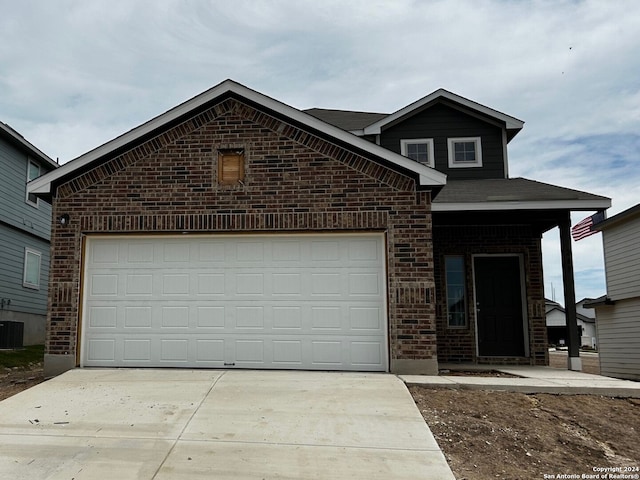 view of front property with cooling unit and a garage