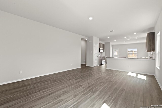 unfurnished living room featuring wood-type flooring