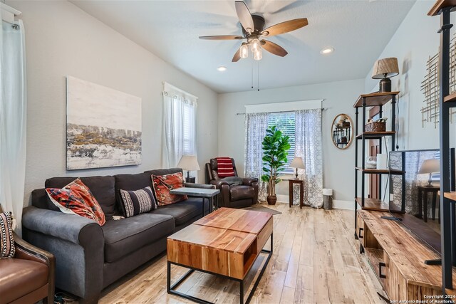 living room with ceiling fan and light hardwood / wood-style floors