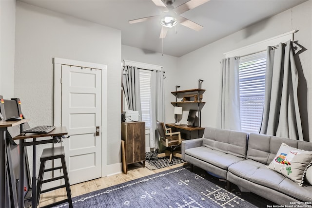 living room with ceiling fan and light wood-type flooring