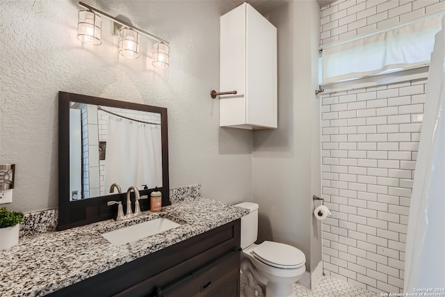 full bath with vanity, a tile shower, tile patterned floors, toilet, and a textured wall