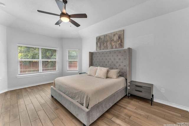 bedroom featuring ceiling fan, vaulted ceiling, and light wood-type flooring