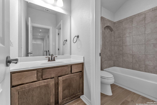 full bathroom with vanity, toilet, and tiled shower / bath combo