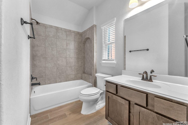 full bathroom featuring vanity, tiled shower / bath combo, wood-type flooring, and toilet