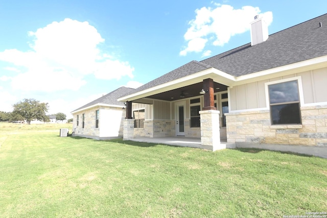 back of house featuring a lawn, a patio, and ceiling fan