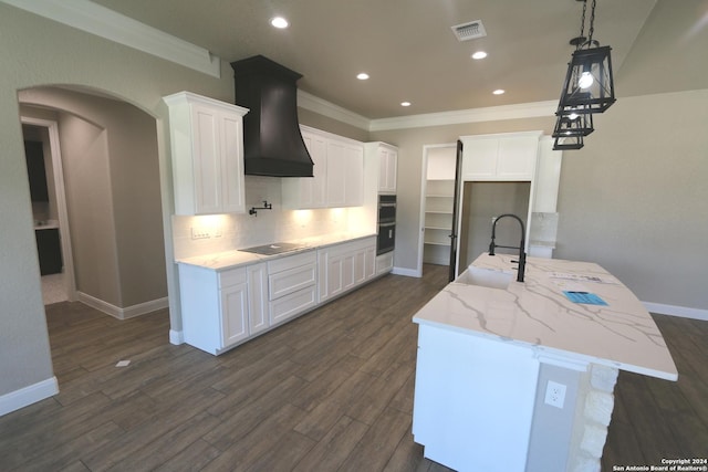 kitchen with white cabinetry, black electric stovetop, and sink