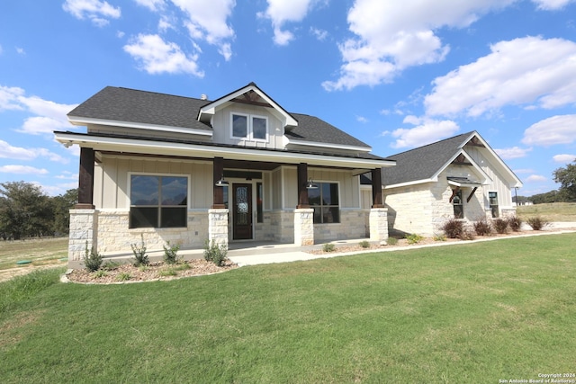 craftsman house with covered porch and a front lawn