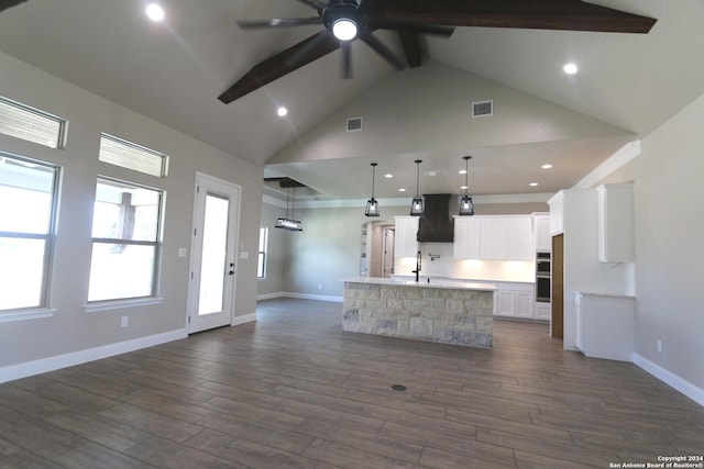 kitchen with a large island, white cabinetry, hanging light fixtures, dark hardwood / wood-style floors, and custom range hood