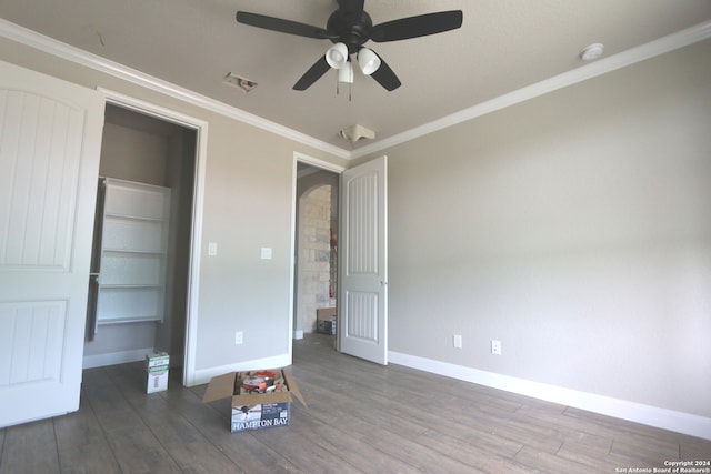 unfurnished bedroom featuring ceiling fan, hardwood / wood-style flooring, and crown molding