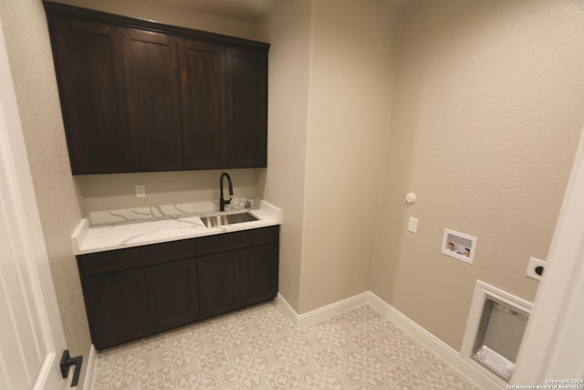 washroom with light tile patterned flooring, sink, cabinets, washer hookup, and hookup for an electric dryer