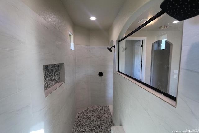 bathroom with tiled shower