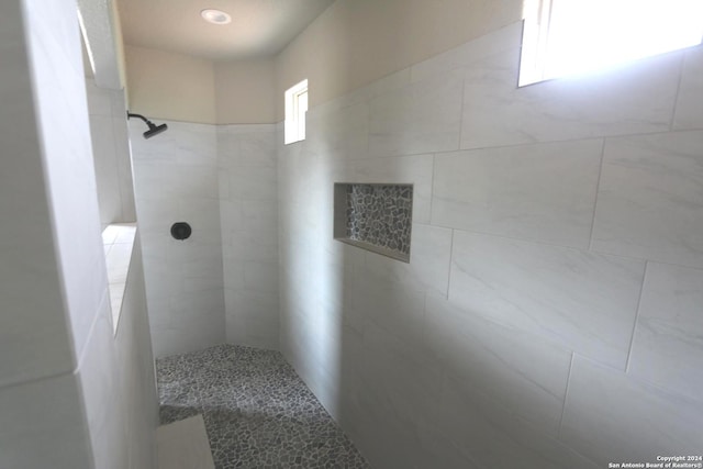 bathroom with tiled shower