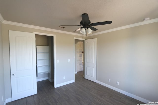 unfurnished bedroom with crown molding, dark wood-type flooring, a closet, and ceiling fan