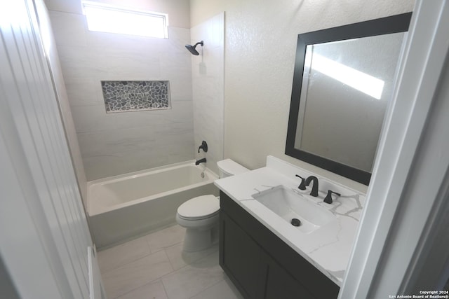 full bathroom featuring tiled shower / bath, vanity, and toilet