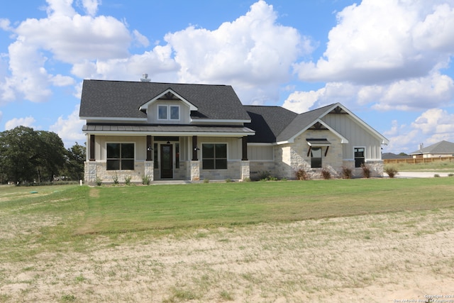 view of front of home featuring covered porch and a front yard