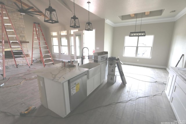 kitchen with hanging light fixtures, light hardwood / wood-style floors, light stone counters, white cabinets, and ceiling fan