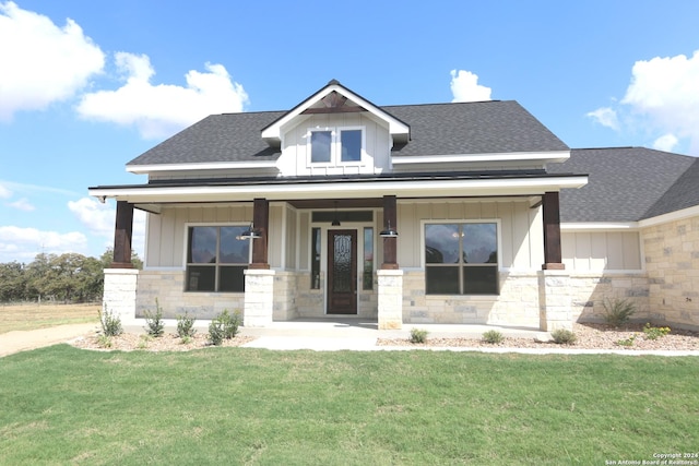 view of front of home featuring a front yard and a porch