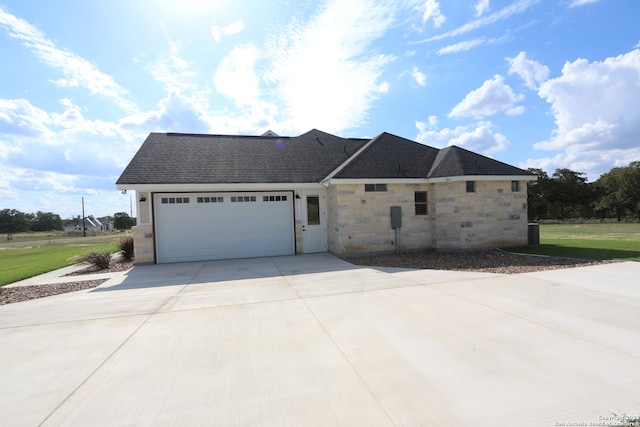 view of front facade with a garage and a front lawn