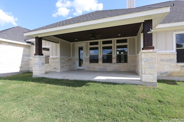 back of house with ceiling fan, a yard, and a patio