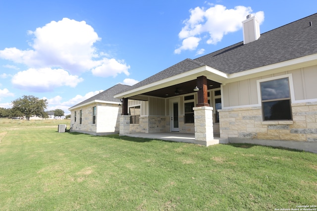 rear view of house with a yard and a patio area