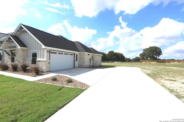 view of front of house featuring a garage and a front lawn