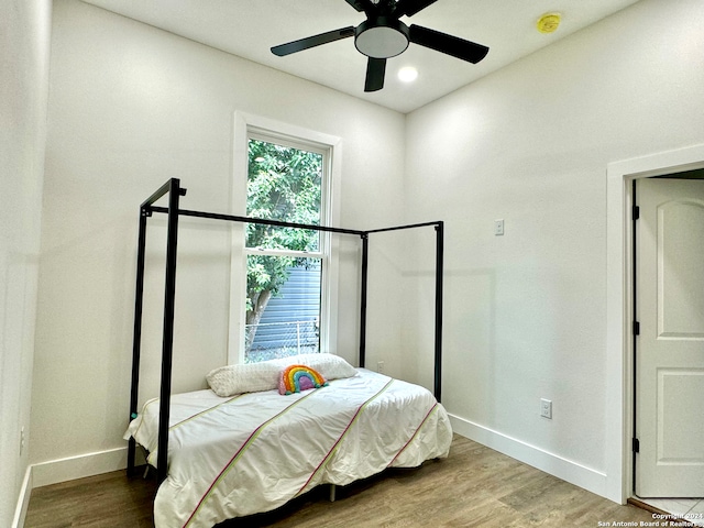 bedroom with hardwood / wood-style floors and ceiling fan