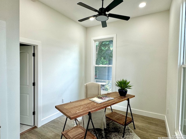 home office with light wood-type flooring and ceiling fan