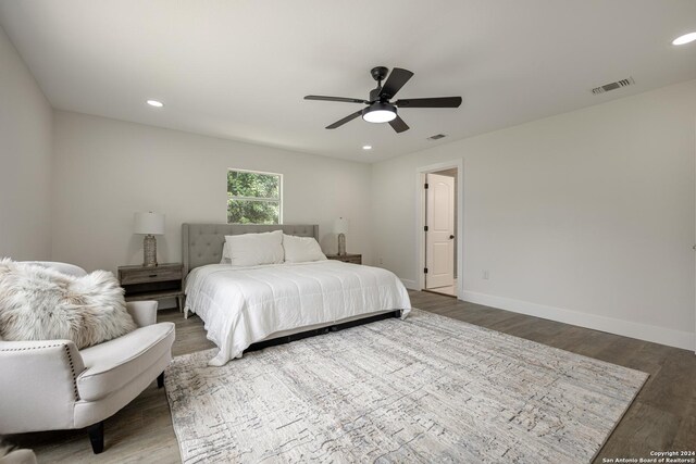 bedroom with hardwood / wood-style floors and ceiling fan