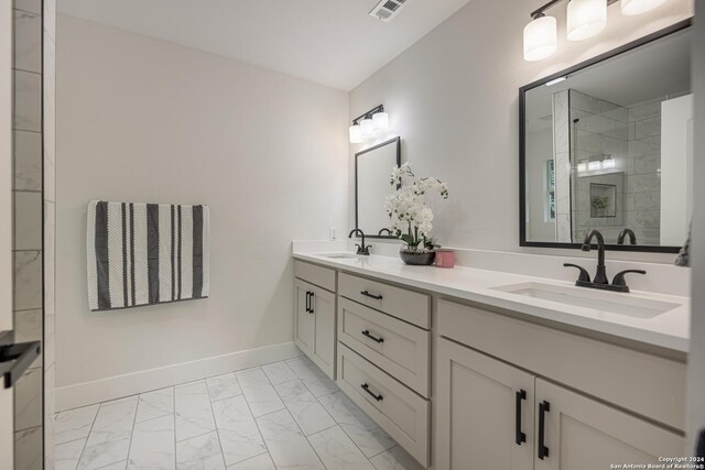 bathroom with tile patterned floors and dual bowl vanity