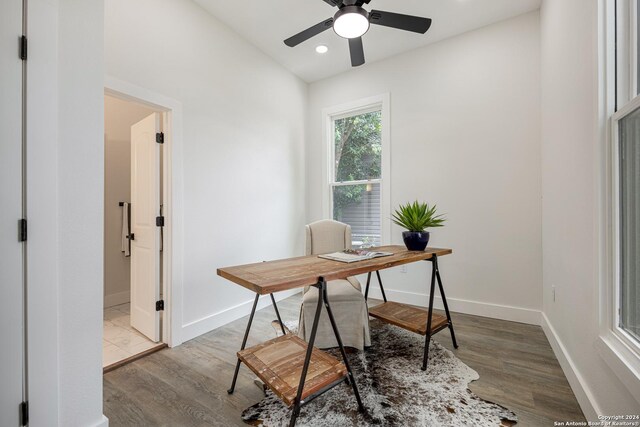 living room featuring beamed ceiling, ceiling fan, and hardwood / wood-style floors