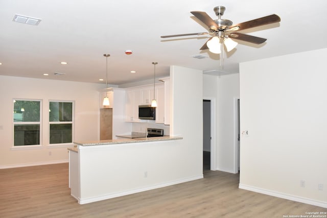 kitchen with visible vents, white cabinetry, light wood-type flooring, electric range oven, and stainless steel microwave