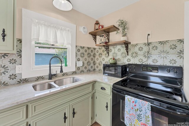 kitchen featuring sink, black range with electric stovetop, and light stone counters