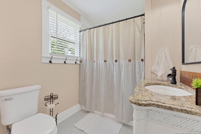 bathroom with vanity, tile patterned flooring, and toilet