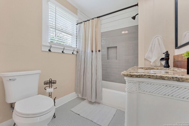 full bathroom with tile patterned floors, toilet, vanity, and shower / tub combo with curtain