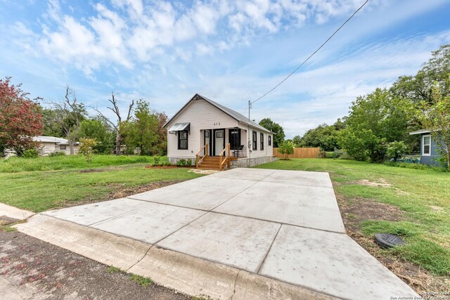 bungalow-style home featuring a front yard