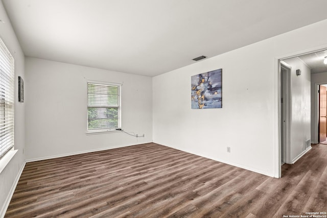 empty room with dark hardwood / wood-style floors