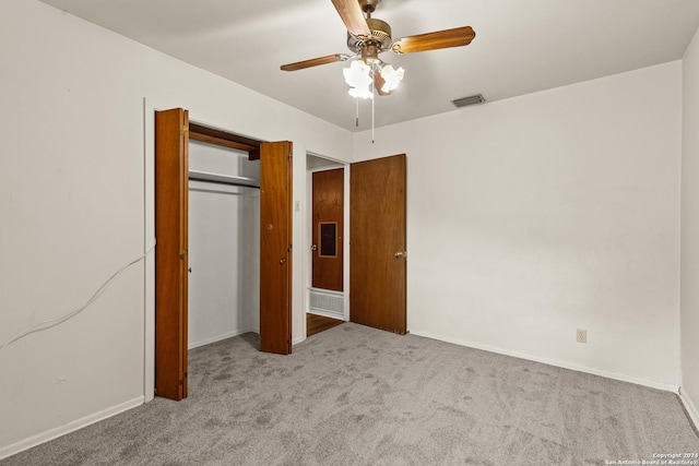 unfurnished bedroom featuring ceiling fan, light colored carpet, and a closet