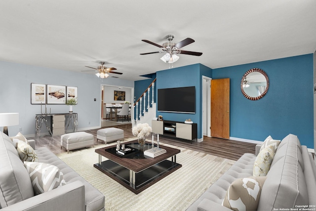 living room featuring hardwood / wood-style floors and ceiling fan