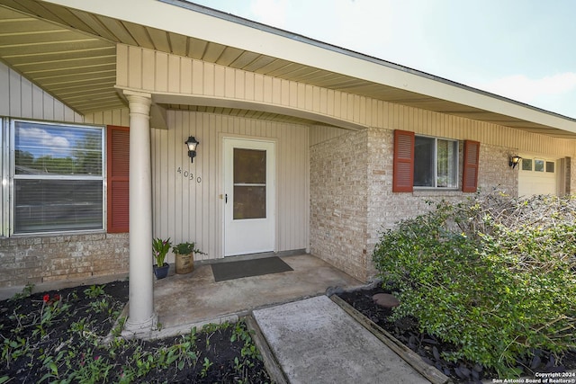 doorway to property with a garage