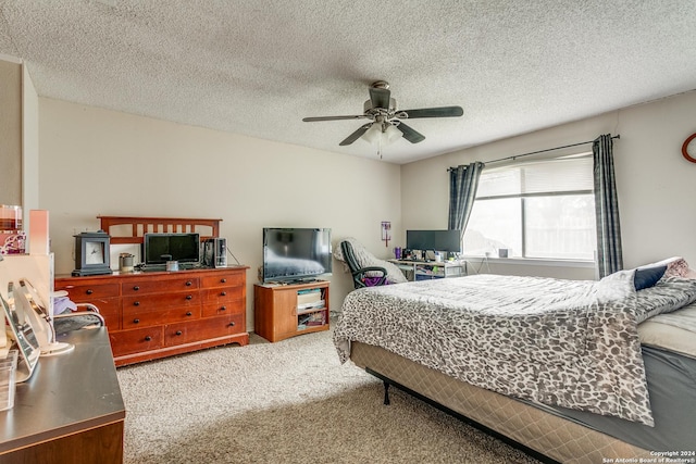 bedroom featuring carpet floors, a textured ceiling, and ceiling fan