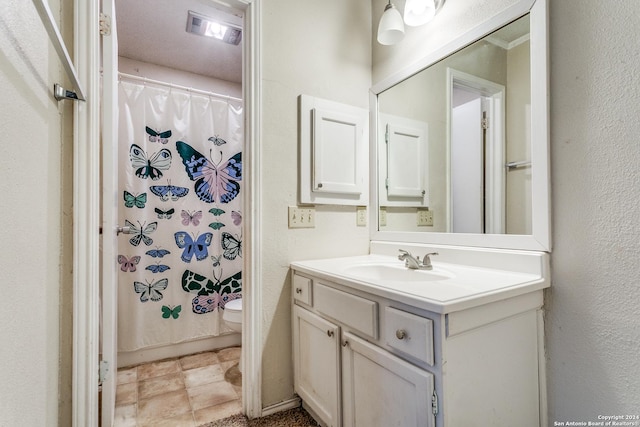 bathroom with vanity, a shower with curtain, and toilet