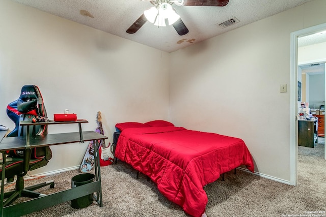 carpeted bedroom with a textured ceiling and ceiling fan