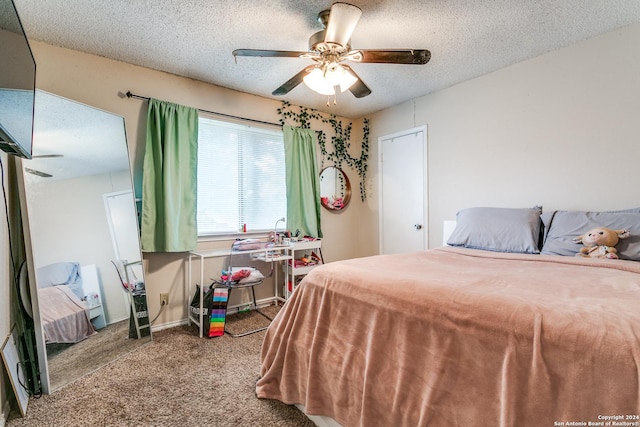 bedroom featuring a textured ceiling, ceiling fan, and carpet flooring