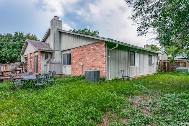 rear view of property featuring cooling unit